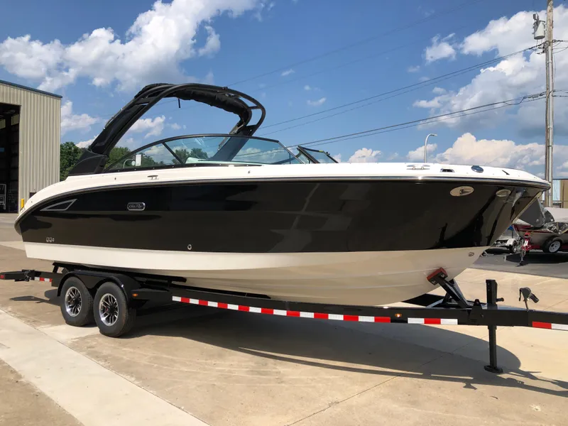 The Image of 2025 Sea Ray SDX 270 boat on trailer, parked outdoors under a clear sky. - 1