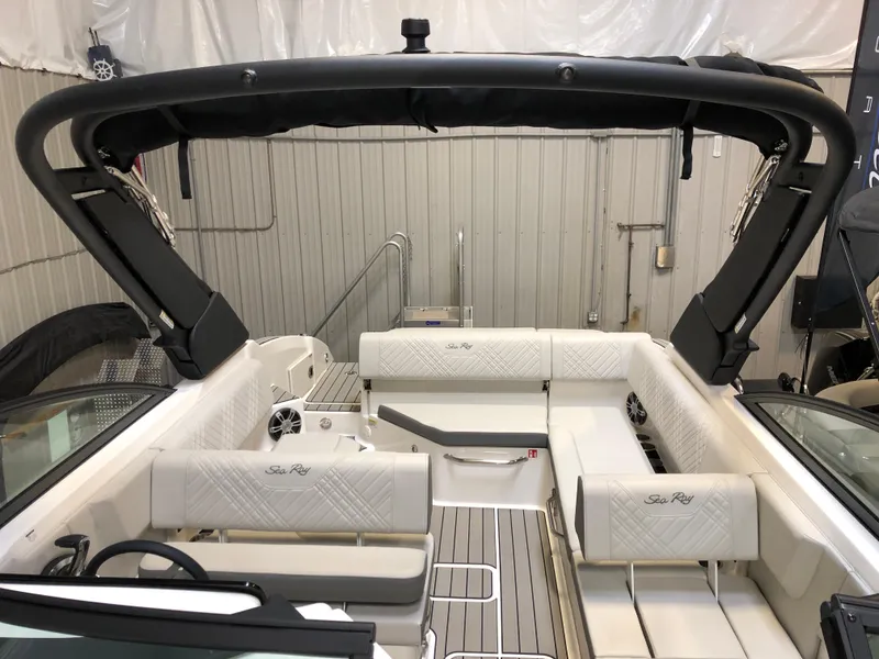 Slide: The Image of 2025 Sea Ray SDX 270 boat interior with white seating and sleek design. - 9