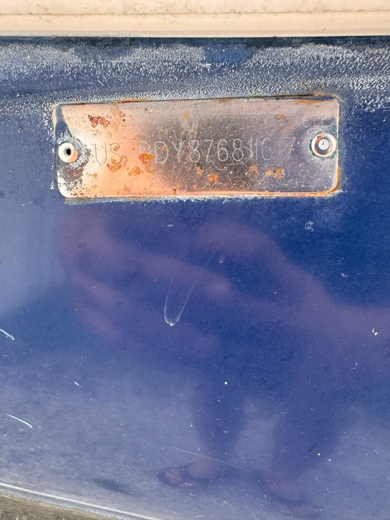 Slide: The Image of Rusty metal identification plate on a blue 2017 Hurricane 2000SD boat. - 11