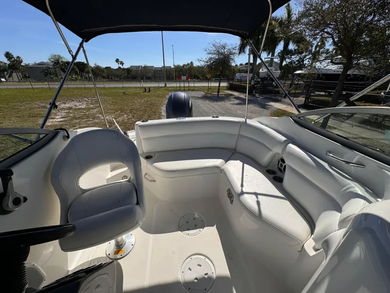 Slide: The Image of Interior of a 2017 Hurricane 2000SD boat with white seating and canopy. - 17