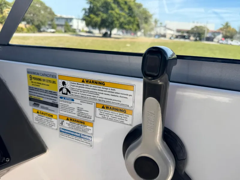Slide: The Image of Throttle control and safety warnings on a 2017 Hurricane 2000SD boat. - 19