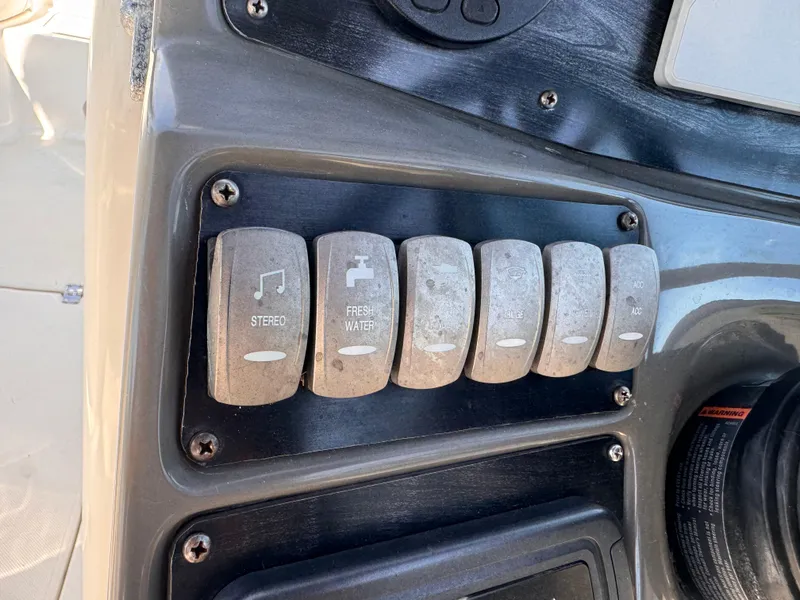 Slide: The Image of Control panel of a 2017 Hurricane 2000SD boat with labeled switches. - 21
