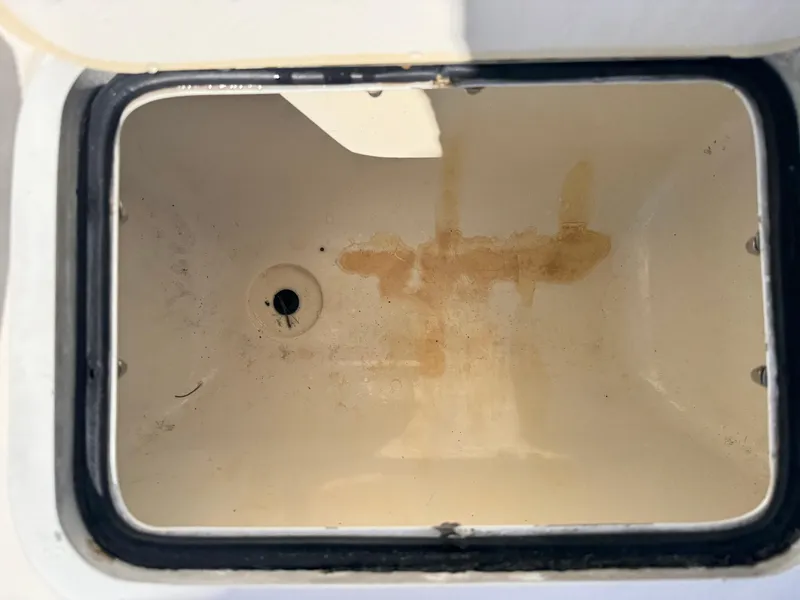 Slide: The Image of Open storage compartment of a 2017 Hurricane 2000SD boat, showing interior stains. - 28