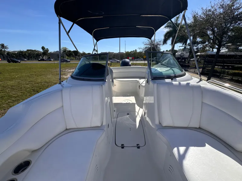 Slide: The Image of 2017 Hurricane 2000SD boat interior with white seating and canopy. - 34