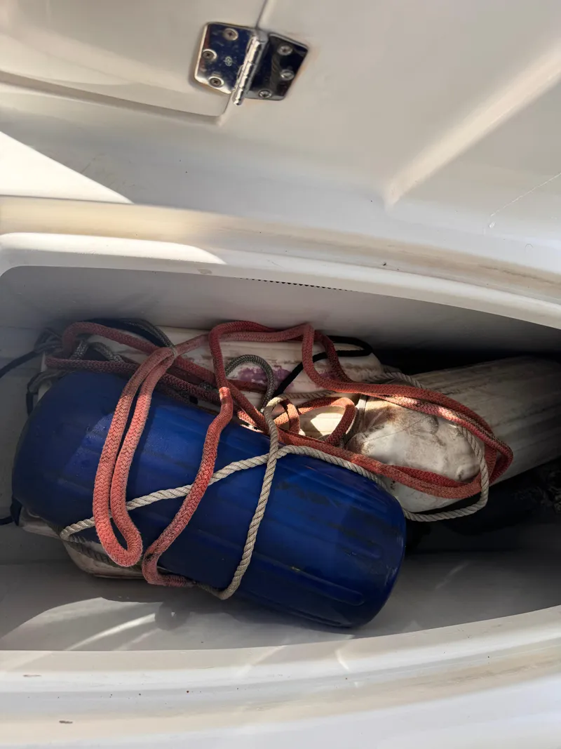 Slide: The Image of Storage compartment with ropes and blue fender on a 2017 Hurricane 2000SD boat. - 36