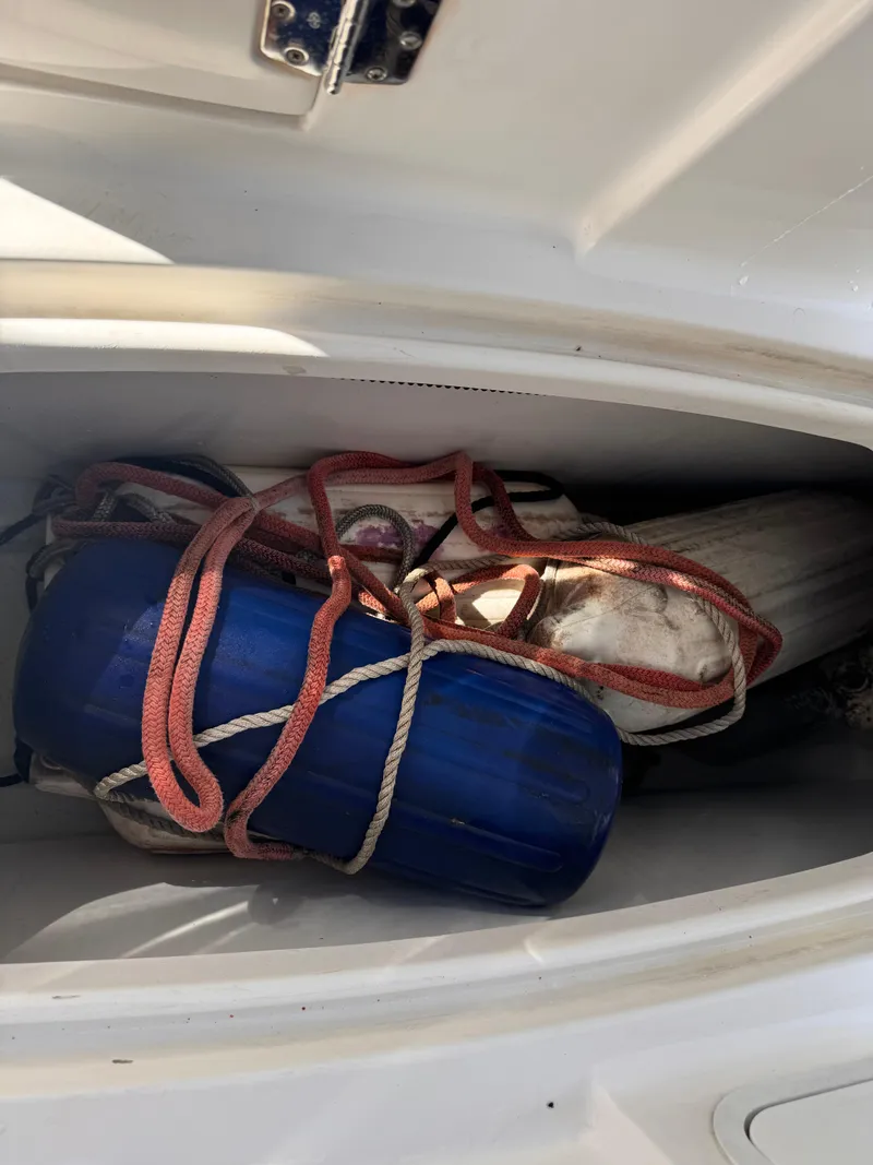 Slide: The Image of Storage compartment of a 2017 Hurricane 2000SD boat with ropes and a blue fender. - 37