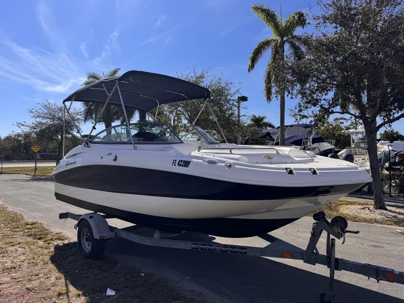 Slide: The Image of 2017 Hurricane 2000SD boat on trailer, parked outdoors under clear blue sky. - 8