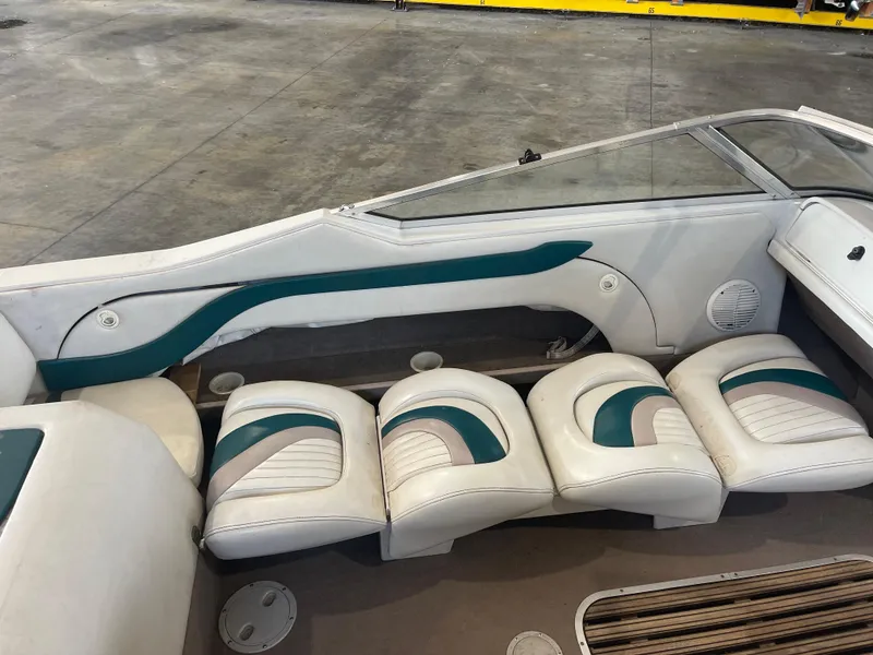 Slide: The Image of Interior of a 1993 Regal 176 SE boat with white and teal seating. - 11