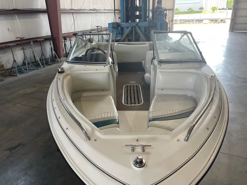 Slide: The Image of 1993 Regal 176 SE boat with white interior, parked indoors. - 14
