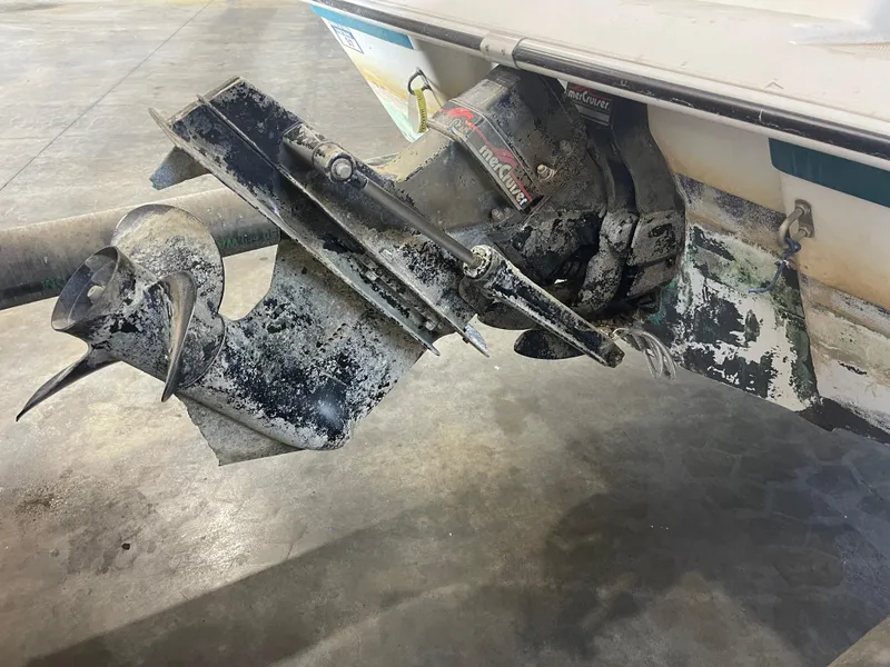 Slide: The Image of 1993 Regal 176 SE boat with weathered MerCruiser outdrive in a garage setting. - 18