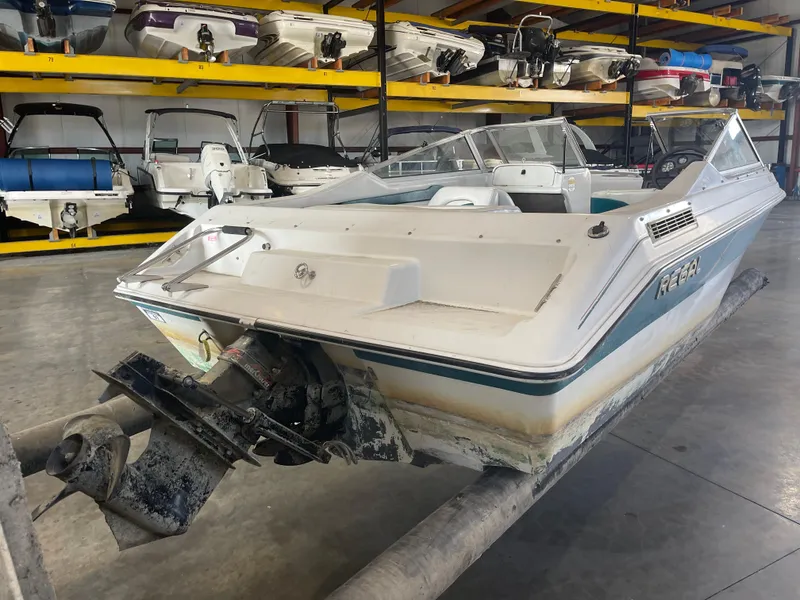 Slide: The Image of 1993 Regal 176 SE boat in storage, surrounded by other boats on racks. - 4