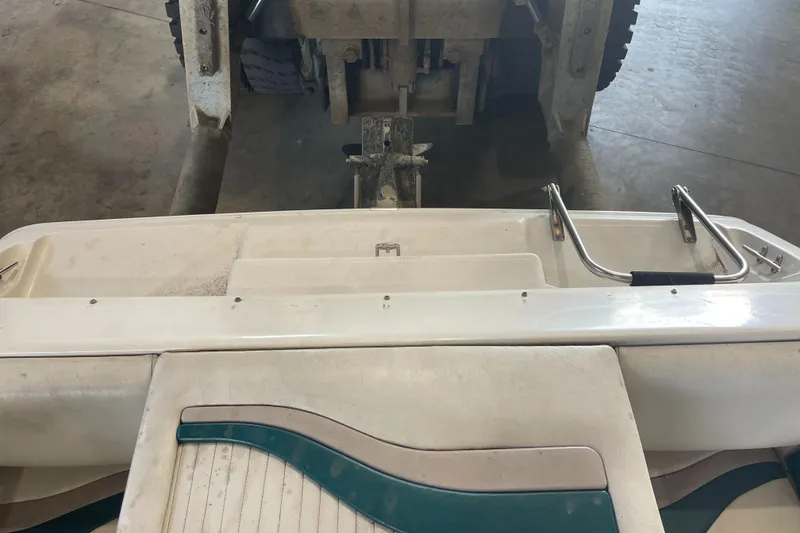 Slide: The Image of 1993 Regal 176 SE boat interior with swim platform and ladder in a garage. - 7