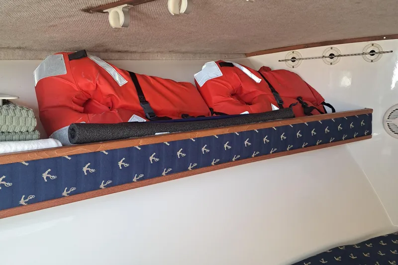 Slide: The Image of Interior of 2003 Carolina Classic 28 Express Sportfisherman with life jackets and nautical decor. - 11