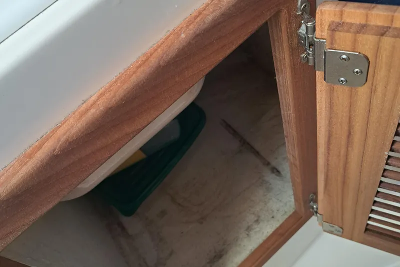 Slide: The Image of Open wooden cabinet on 2003 Carolina Classic 28 Express Sportfisherman boat. - 19