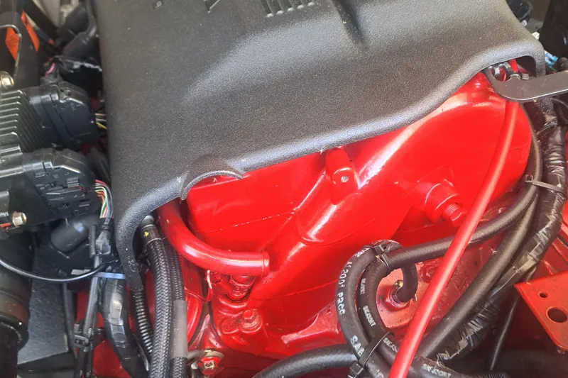 Slide: The Image of Engine of a 2003 Carolina Classic 28 Express Sportfisherman, featuring red components and wiring. - 24