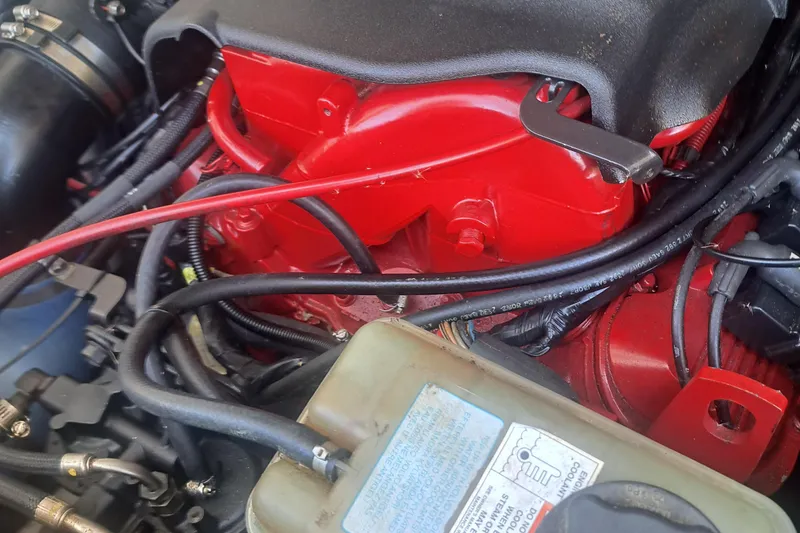 Slide: The Image of Engine compartment of a 2003 Carolina Classic 28 Express Sportfisherman, featuring red components and wiring. - 25
