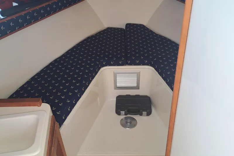 Slide: The Image of 2003 Carolina Classic 28 Express Sportfisherman cabin interior with patterned cushions. - 9