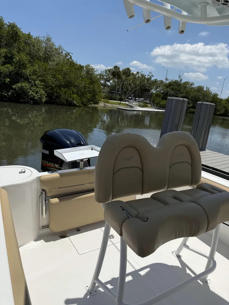 Slide: The Image of 2016 Tidewater 230 CC Adventure boat docked by a serene riverbank. - 10