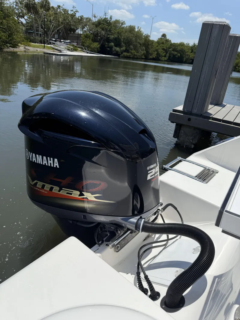 Slide: The Image of 2016 Tidewater 230 CC Adventure with Yamaha VMAX outboard motor docked by a calm river. - 13