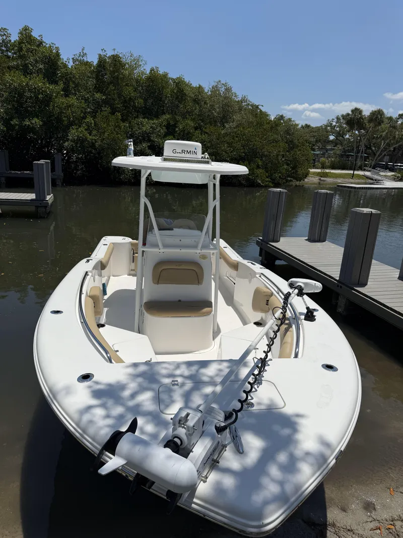 Slide: The Image of 2016 Tidewater 230 CC Adventure boat docked by a wooden pier. - 16
