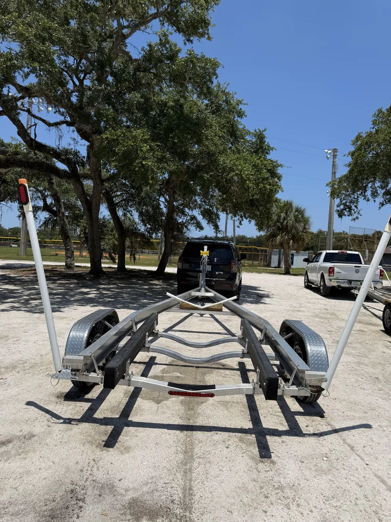 Slide: The Image of Boat trailer for 2016 Tidewater 230 CC Adventure, parked under trees in a sunny lot. - 7