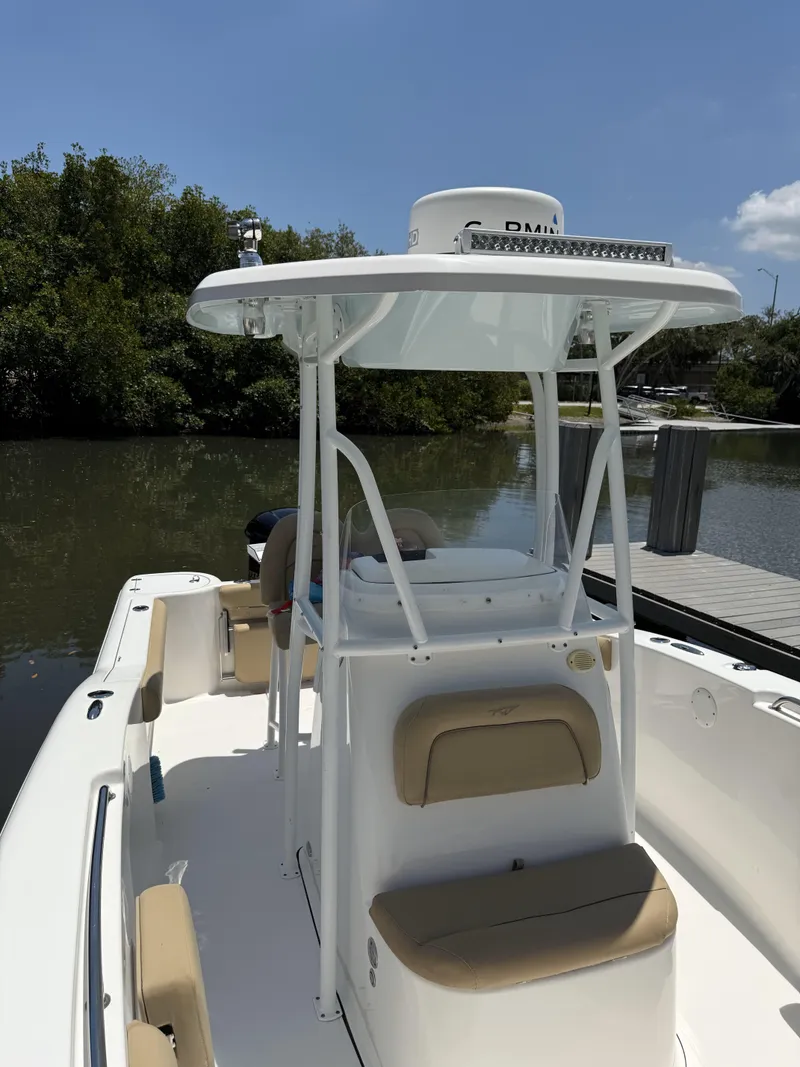 Slide: The Image of 2016 Tidewater 230 CC Adventure boat docked by a calm river. - 8