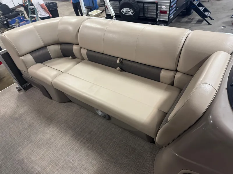Slide: The Image of 2021 Sun Tracker Party Barge 20 DLX, beige seating, spacious interior, showroom display. - 7