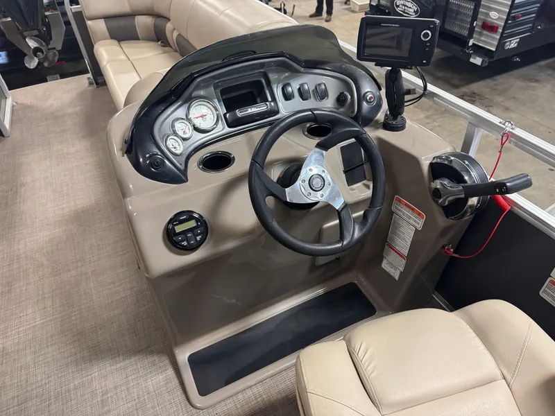 Slide: The Image of 2021 Sun Tracker Party Barge 20 DLX helm with steering wheel and control panel. - 8
