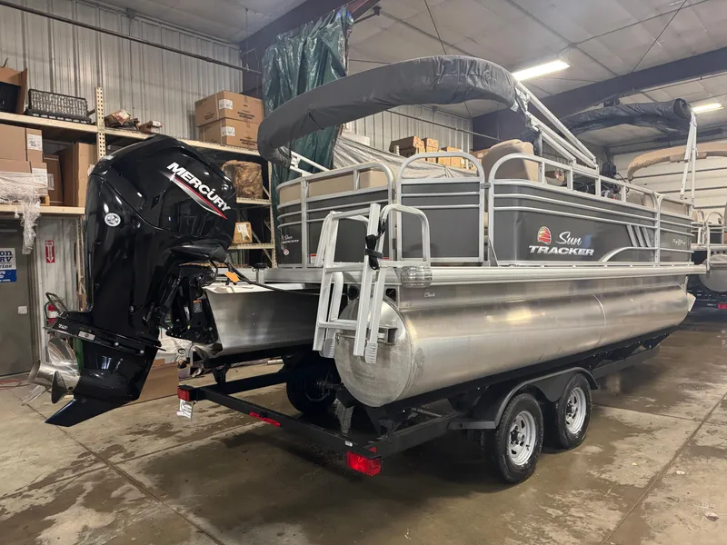 Slide: The Image of 2021 Sun Tracker Party Barge 20 DLX pontoon boat in a storage facility. - 3