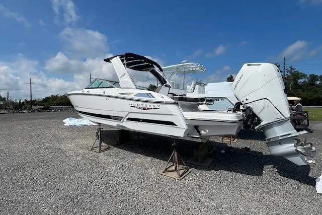 Slide: The Image of 2026 Monterey 275 Super Sport boat on stands, displayed outdoors under a clear sky. - 3