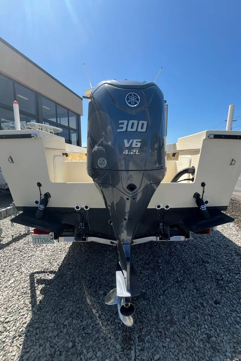 Slide: The Image of 2024 Jones Brothers Cape Fisherman 26 with Yamaha 300 V6 engine, displayed outdoors. - 14