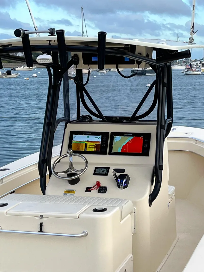 Slide: The Image of 2024 Jones Brothers Cape Fisherman 26 Light Tackle boat dashboard with navigation screens. - 5