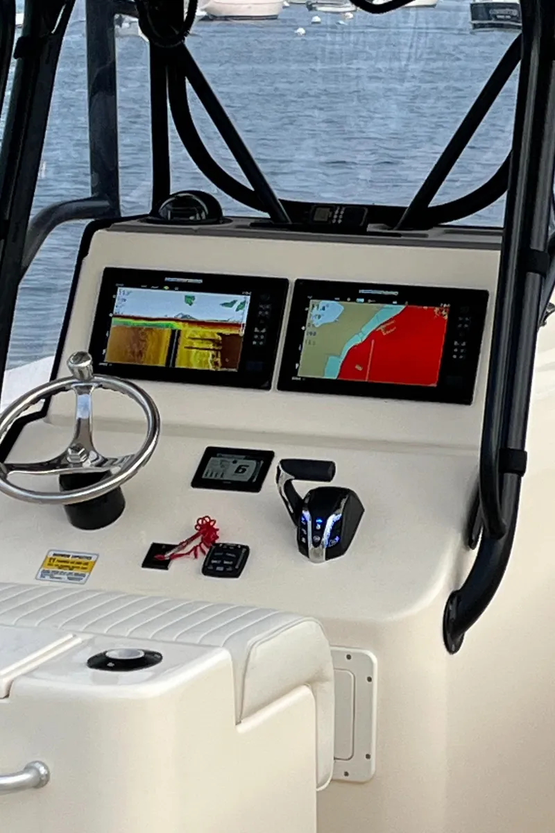 Slide: The Image of 2024 Jones Brothers Cape Fisherman 26 Light Tackle boat dashboard with navigation screens. - 6