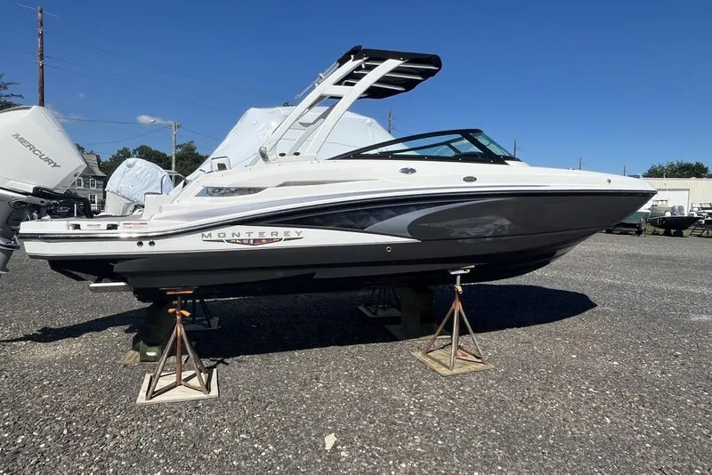 The Image of 2026 Monterey M-45 boat on stands, featuring sleek design and Mercury outboard engines. - 1