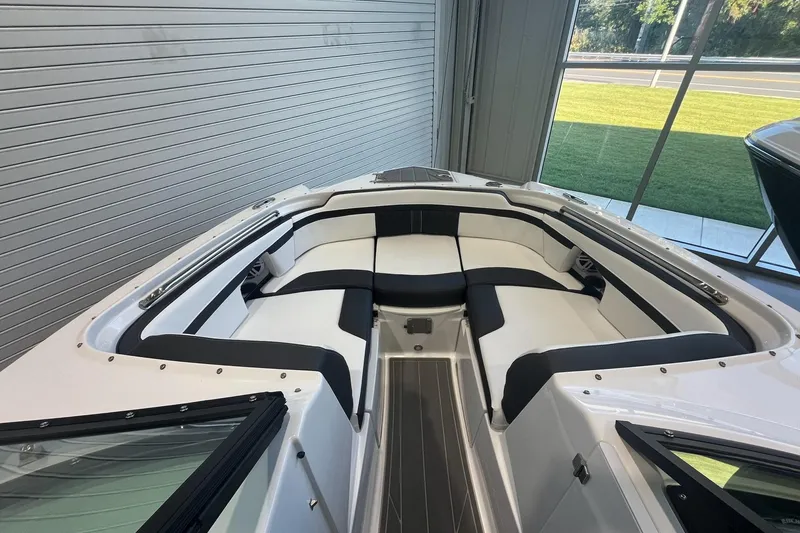 Slide: The Image of 2026 Monterey M-45 boat interior with sleek white and black seating in a showroom. - 10