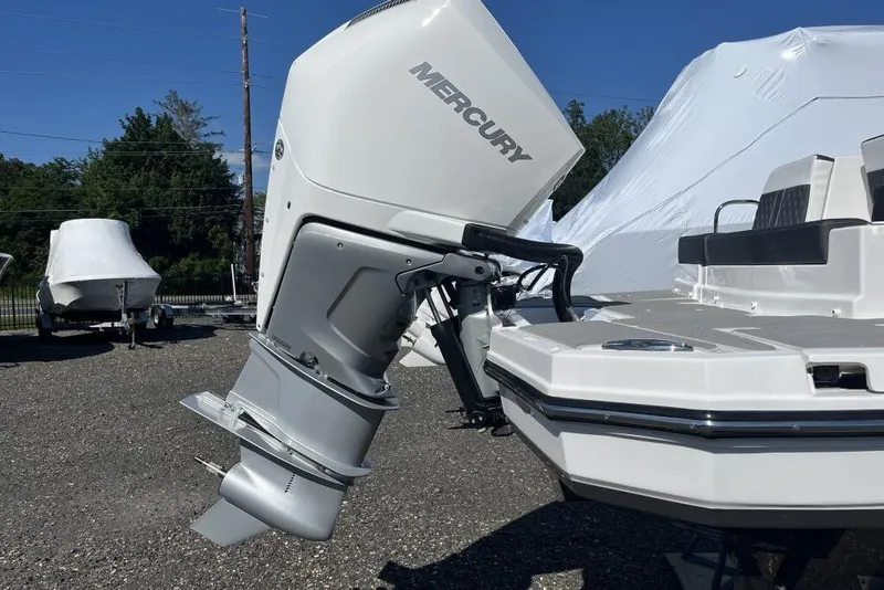 Slide: The Image of 2026 Monterey M-45 boat with Mercury outboard motor in a sunny outdoor setting. - 13