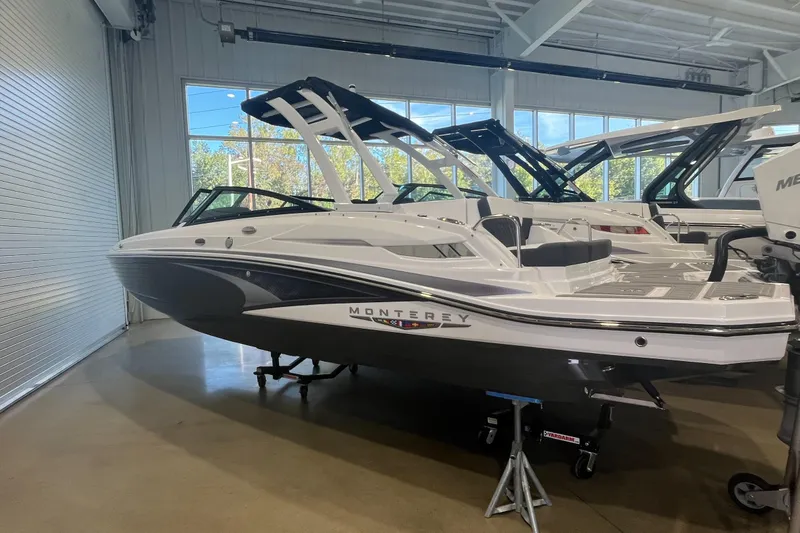 Slide: The Image of 2026 Monterey M-45 boat displayed in a showroom, featuring sleek design and modern features. - 2