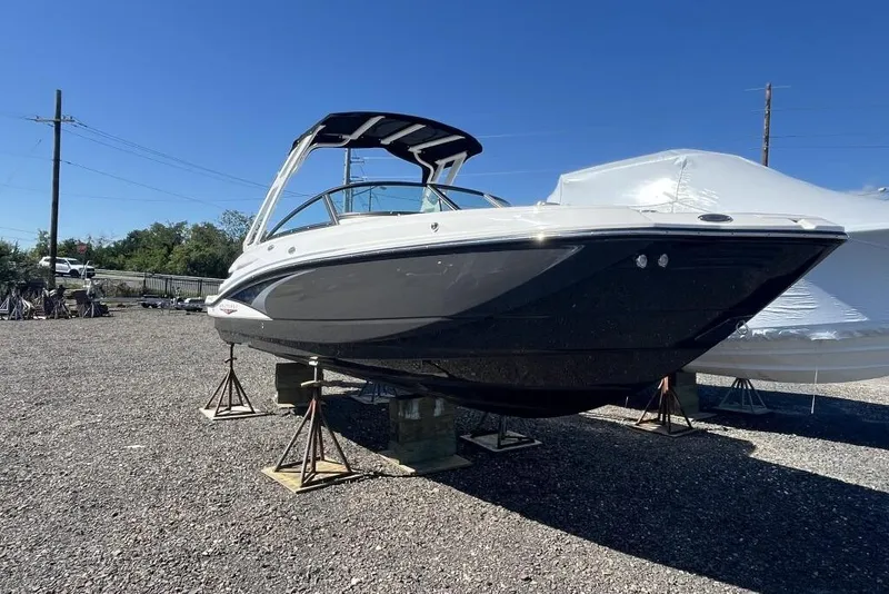 Slide: The Image of 2026 Monterey M-45 boat on stands in a gravel lot under clear blue sky. - 3