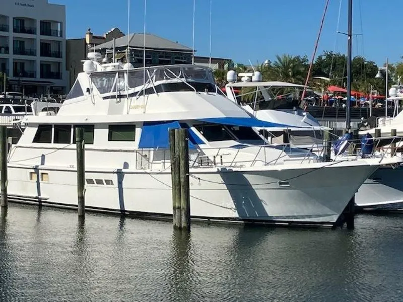 The Image of 1996 Hatteras 70 Sport Deck Motor Yacht docked in marina, sunny day. - 1
