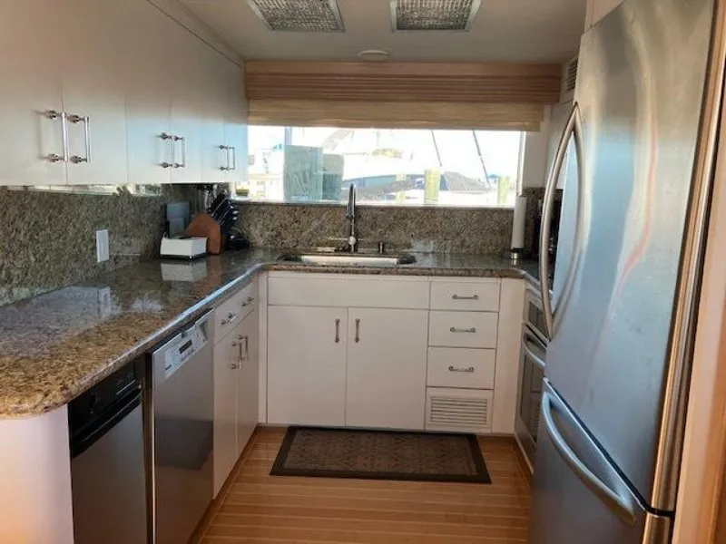 Slide: The Image of Modern kitchen in 1996 Hatteras 70 Sport Deck Motor Yacht with granite countertops and stainless steel appliances. - 19