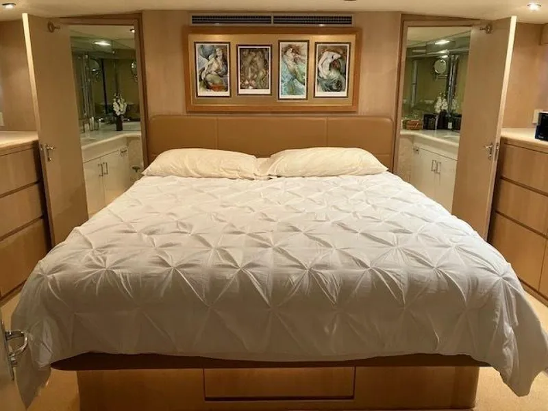 Slide: The Image of Luxurious bedroom in 1996 Hatteras 70 Sport Deck Motor Yacht with elegant decor. - 22