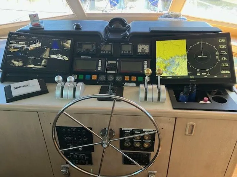 Slide: The Image of Control panel of a 1996 Hatteras 70 Sport Deck Motor Yacht with navigation screens. - 28