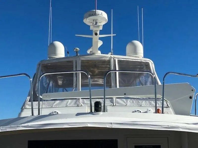 Slide: The Image of 1996 Hatteras 70 Sport Deck Motor Yacht with radar equipment against clear blue sky. - 4