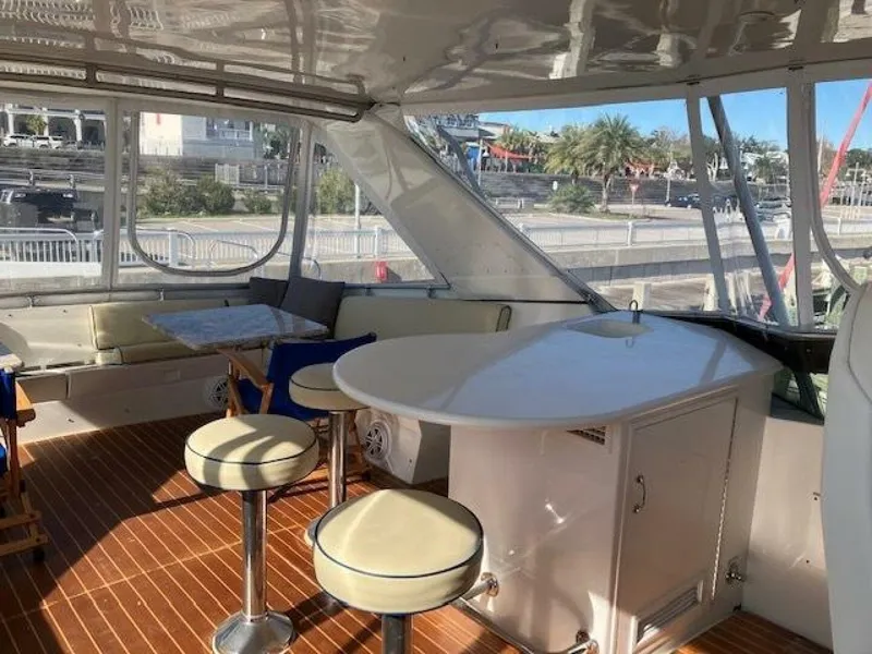 Slide: The Image of Interior of 1996 Hatteras 70 Sport Deck Motor Yacht with seating and table. - 6