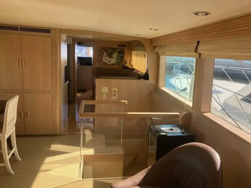 Slide: The Image of Interior of 1996 Hatteras 70 Sport Deck Motor Yacht with wooden finishes and large windows. - 15