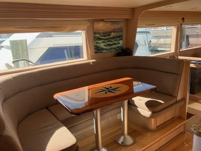 Slide: The Image of Interior of 1996 Hatteras 70 Sport Deck Motor Yacht with elegant dining area. - 16
