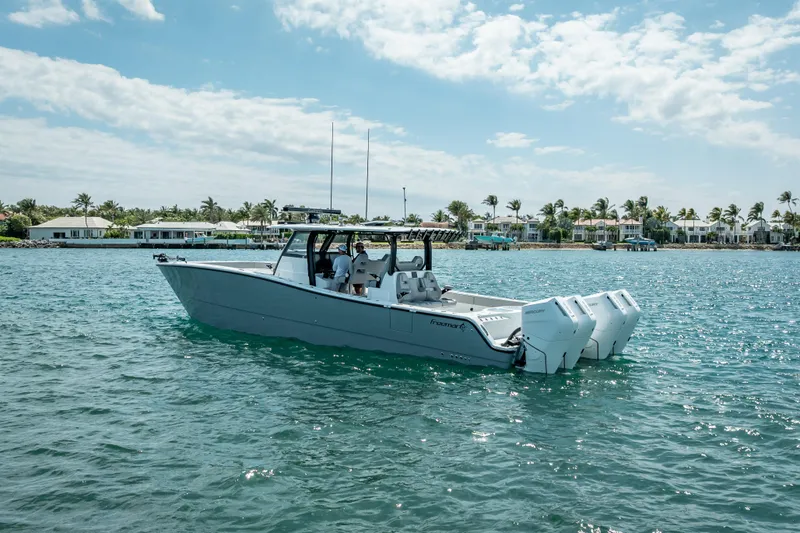 The Image of 2024 Freeman 42LR boat on water, with coastal homes in the background. - 0