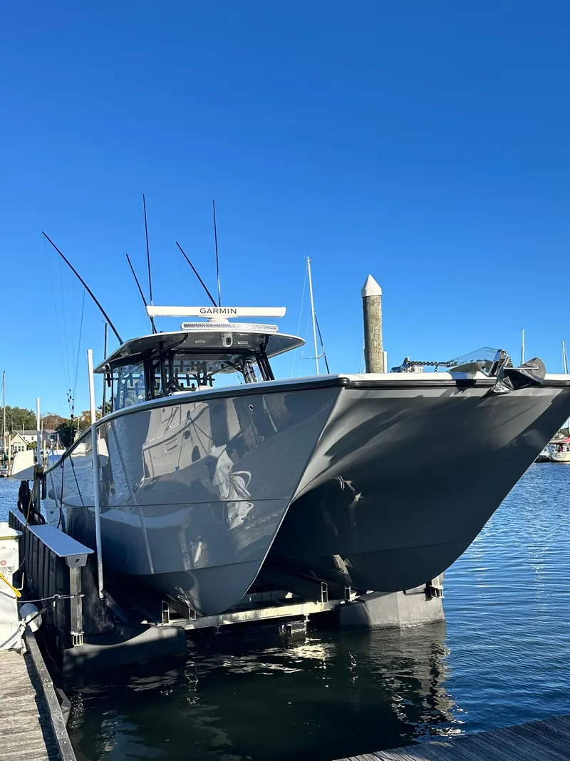 Slide: The Image of 2024 Wyatt and Freeman 42LR boat docked at marina under clear blue sky. - 4