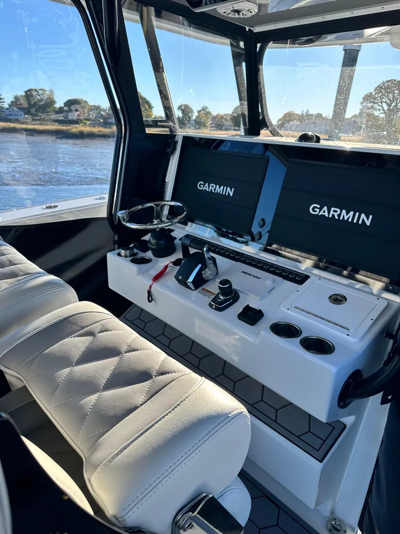 Slide: The Image of Luxurious 2024 Wyatt and Freeman 42LR boat interior with Garmin navigation displays. - 6