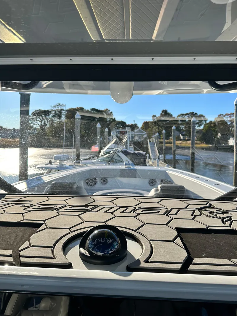 Slide: The Image of 2024 Wyatt and Freeman 42LR boat interior with compass, docked at marina. - 8